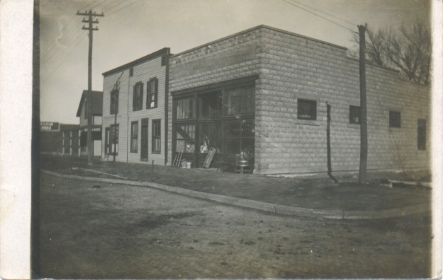 A postcard featuring a building at the corner of 1st and Main in Ottawa, Kansas.