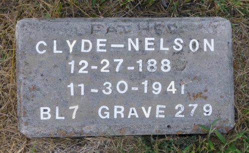 The grave of Clyde Nelson, a father, is one of only two stones bearing a name instead of a number.